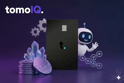The Tomo Card alongside the TomoIQ mascot and a stack of coins and crystals