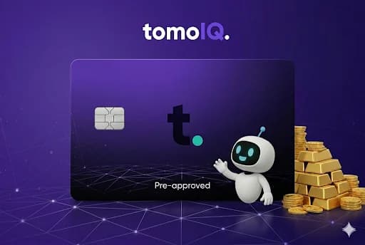 The TomoIQ mascot standing next to a Tomo Card and a stack of gold coins